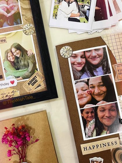 Another close-up of the scrapbook collection, showing the texture of the dried flowers and the details on the photo frame and card.