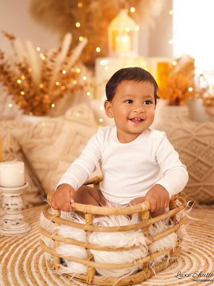 A radiant smile from this sweet baby boy in our warm, cozy boho setup. This theme is perfect for capturing simple, happy milestone portraits.