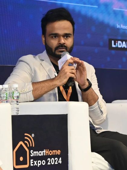 A young innovator shares his perspective on a panel, representing the fresh ideas and new talent in the industry.