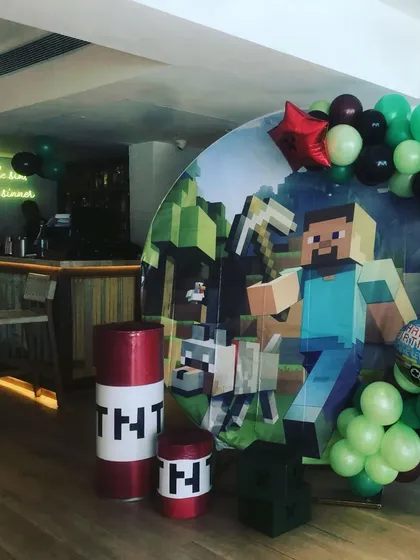 A close-up of the Minecraft party backdrop, showing the detailed print and character cutouts that make the theme so immersive for kids.