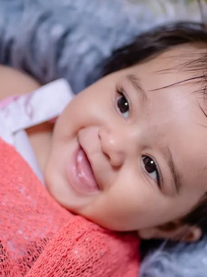 Sweet smiles and endless giggles. This close-up shot captures the pure happiness of a baby.