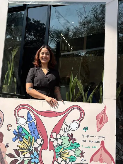 Our pleasure coach and sexuality educator, Aparupa, standing by the beautiful mural outside our clinic.