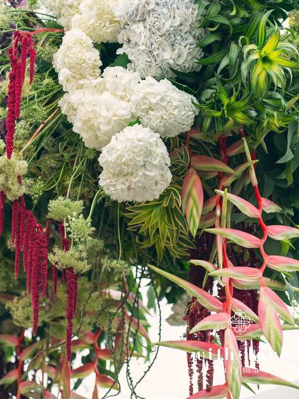 A hanging floral installation from the 'Garden of Gaia' event, with lush greenery and colorful blooms.