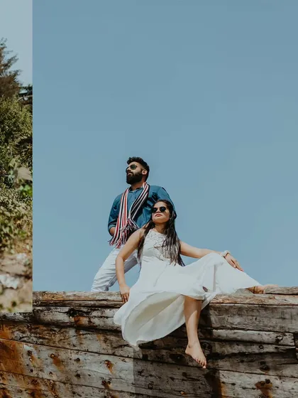 A stylish shot of a couple posing on an old wooden boat in Alibag, exuding confidence and modern style.