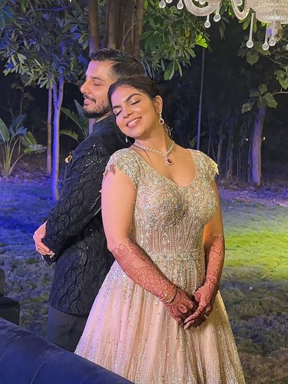 A sweet and romantic moment between the couple at their Sangeet. Her makeup is glowing and glamorous, perfect for the occasion.