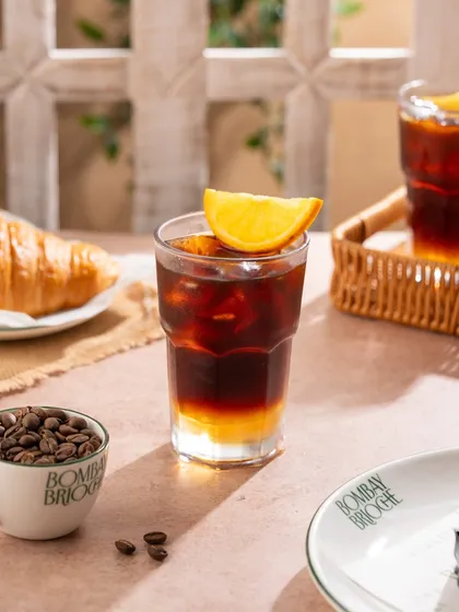 An orange-infused iced coffee, a refreshing and unique beverage option.