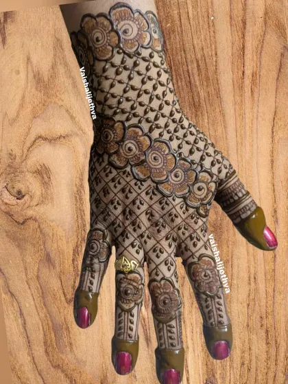 A heavy and intricate back-hand design. The checkered pattern is filled with floral motifs, creating a rich and dense look.