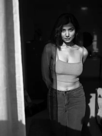An indoor series using shadows from a window to create patterns on the subject. This shows a creative approach to using natural light in a domestic setting.