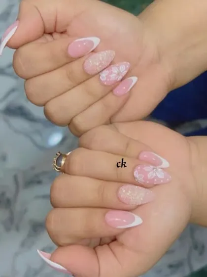 Both hands showcasing the French manicure with 3D floral accents. It's a perfect blend of classic elegance and modern nail art.
