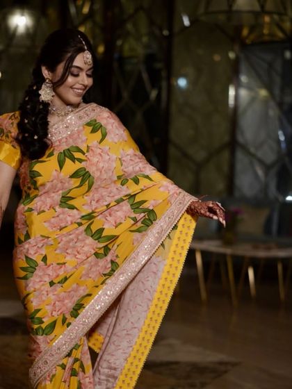 The beautiful floral saree is the star, and the makeup is its perfect, subtle companion. This Haldi look is all about effortless, natural beauty.