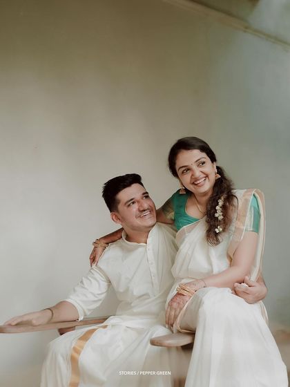 A happy and relaxed portrait of the couple, their smiles natural and full of love.