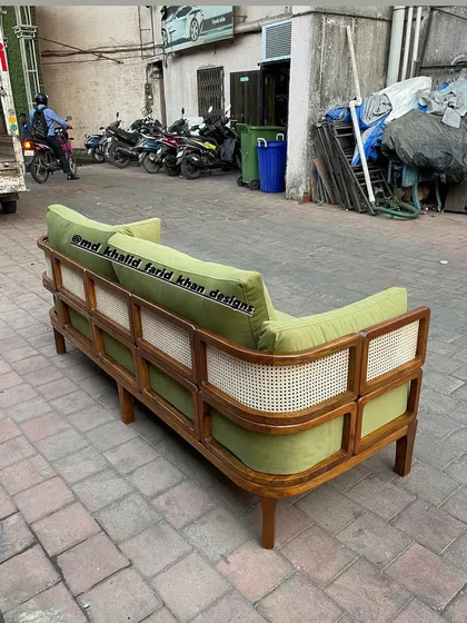 Back view of the green caned sofa.