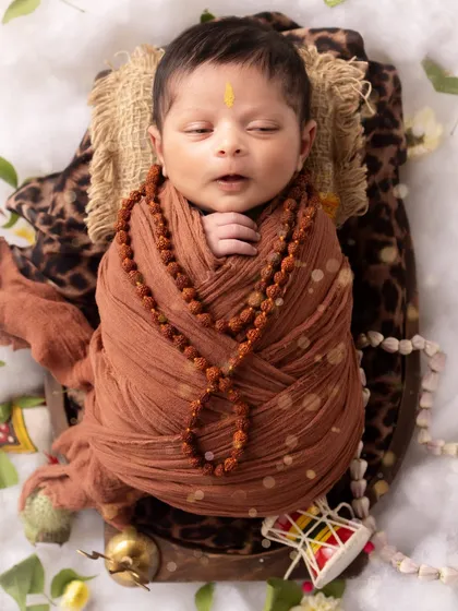 A tiny yawn from our baby Mahadev. These real, unposed moments are just as precious as the smiles.