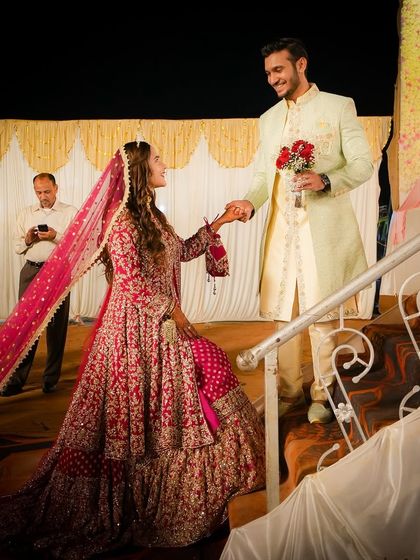 This beautifully composed shot captures the couple in a moment of quiet connection during their reception. We look for these opportunities to create stunning, portrait-like images that highlight your love story amidst the grand celebration.