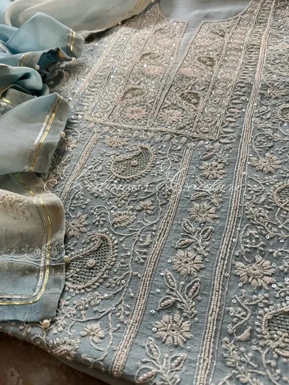 A close-up of the paisley and floral motifs on the kurta.