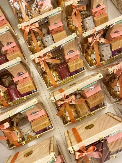 A large batch of our luxury Diwali trunk hampers, shrink-wrapped and ready for delivery. This demonstrates our capability to handle high-volume orders efficiently.