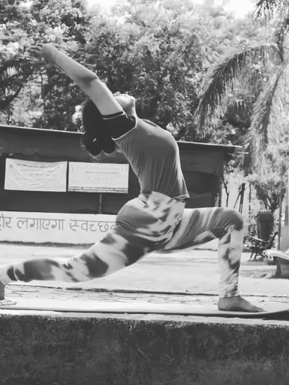 A black and white shot of a high lunge with a backbend. This pose, Anjaneyasana, is a powerful stretch for the hip flexors and a great way to practice the "skill in action" that is yoga.