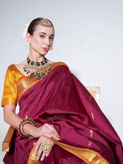 A full seated view of the elegant silk saree look, perfect for a more traditional function or for the mother of the bride.