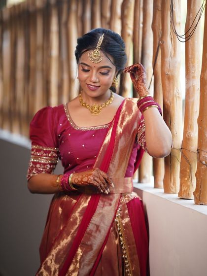 A candid portrait of a bride in a modern half-saree. Her makeup is simple and elegant, with a focus on natural beauty.