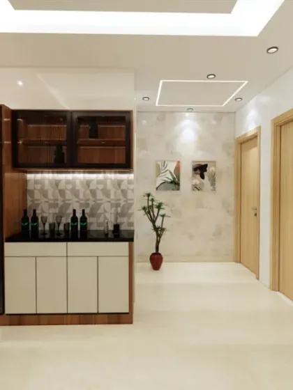 This view highlights a custom-built bar and crockery unit in a spacious hallway. The dark wood and glass cabinet is perfect for storing and displaying glassware and fine spirits.