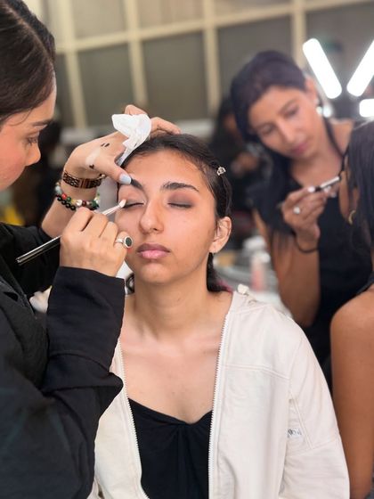 A close-up of students practicing makeup application. We provide a supportive space for learning and experimentation.