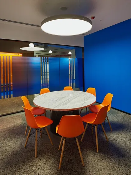 Another view of the orange and blue meeting room, showing how the colors create a powerful visual statement.