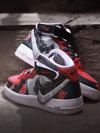 A full view of the Itachi custom Nike Air Force 1 Mids. The design balances character art with abstract patterns and a strong color scheme.
