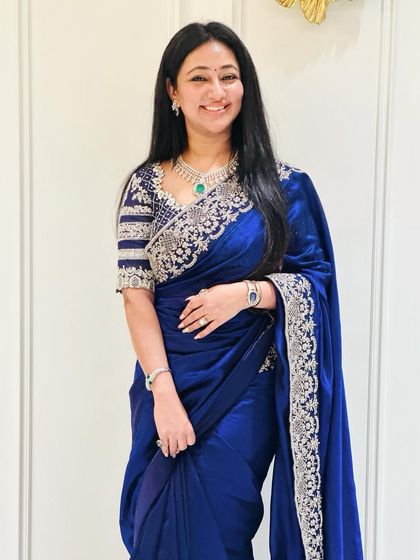 A guest looking elegant in a royal blue saree with a silver embroidered border and a matching custom-designed blouse. This shows our versatility for non-bridal couture as well.