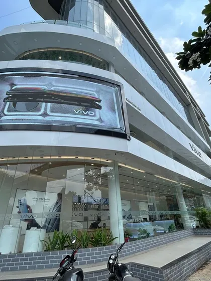 The completed facade of the VIVO flagship showroom in Ahmedabad, a multi-story commercial project we executed. This demonstrates our capability in handling large-scale retail construction, from structural work to the final branding and high-end finishes that define a modern commercial building.