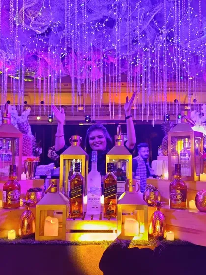 Imagine a night of pure opulence with my Great Gatsby themed bar. The combination of dramatic purple lighting, cascading fairy lights, and candle-lit lanterns creates an immersive, high-energy ambiance for your sangeet or reception.