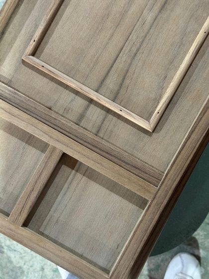 A custom wooden panel with intricate inlays, being prepared in the workshop. This level of detail and craftsmanship is a hallmark of our bespoke furniture design.