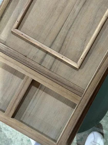 A custom wooden panel with intricate inlays, being prepared in the workshop. This level of detail and craftsmanship is a hallmark of our bespoke furniture design.