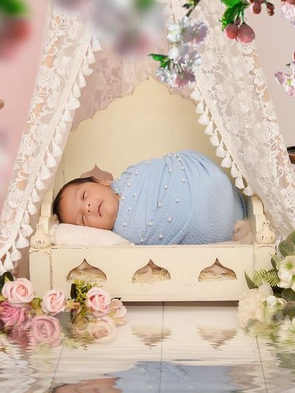 A magical shot of a baby in a lace tent setup with a water reflection effect added in post-production. This creates a stunning, ethereal final image.