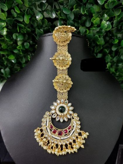 A unique multi-layered maang tikka with a traditional design, perfect for a royal bridal look.
