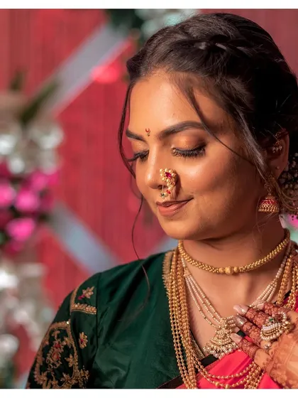 Aditi's new-age Marathi bridal look featured copper hues on the eyes and skin that looked like skin. Paired with beautiful jewels and a modern braided hairstyle, her look was a perfect blend of tradition and contemporary style.