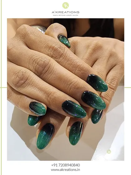 A beautiful example of a smooth color transition. These almond-shaped nails feature a deep emerald green to black ombre effect, creating a glossy, jewel-toned look that is both moody and sophisticated.