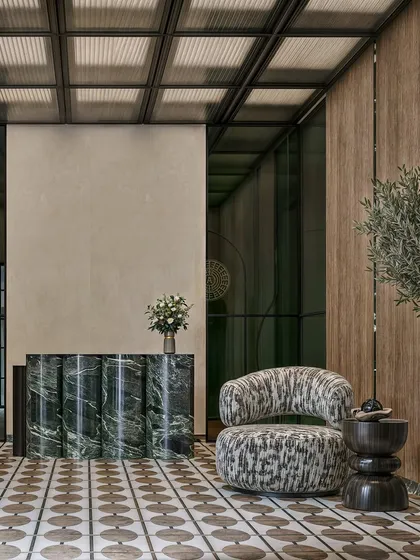 The reception area is the first impression of your company. For this Kolkata office, we designed a calm, sophisticated lobby using a fluted green marble desk, patterned flooring, and an abstract armchair to create a welcoming yet impressive entrance for visitors.