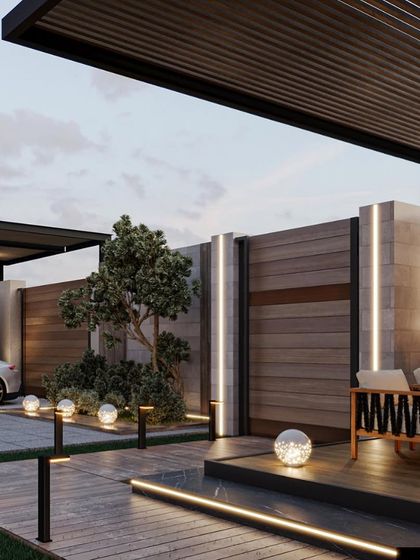 This view of the backyard oasis shows how we integrate different functional zones, including a covered seating area, a driveway, and landscape lighting, into one cohesive design.