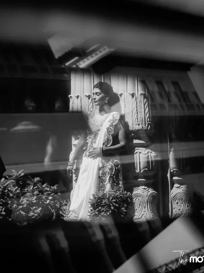 An artistic black and white portrait of the bride, captured through a reflection. This moody and elegant shot highlights the timeless beauty of the bride and the heritage location.