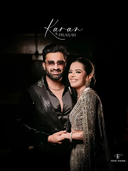 A classic portrait of Karan and Pranavi from their cocktail night. The dark background and focused lighting highlight their stylish outfits and the sparkling connection between them.
