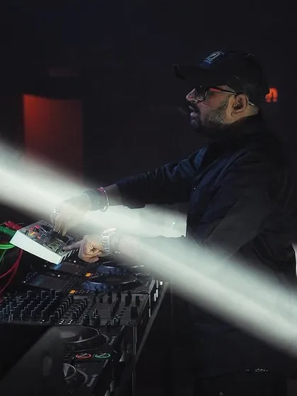Caught in the zone, mixing tracks under the spotlight. This is my focus point, where it's just me, the music, and the energy of the room. Every beat is intentional, crafted to keep the party going.