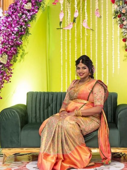 The gorgeous Sukrutha seated at her baby shower. Her makeup is radiant and her traditional attire is simply stunning, creating a picture of pure elegance.