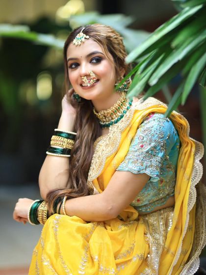 A close up of the bride, showing her beautiful smile and the soft waves in her hair. The maang tikka adds a perfect touch of sparkle.