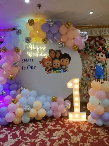 A sweet and simple Cocomelon ring setup in pastel colors, perfect for a first birthday celebration.