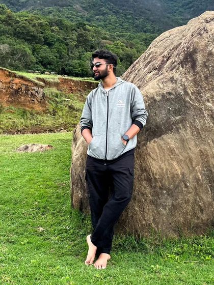 Taking a moment to relax by a large rock in the Ooty countryside. It's important to have downtime too.