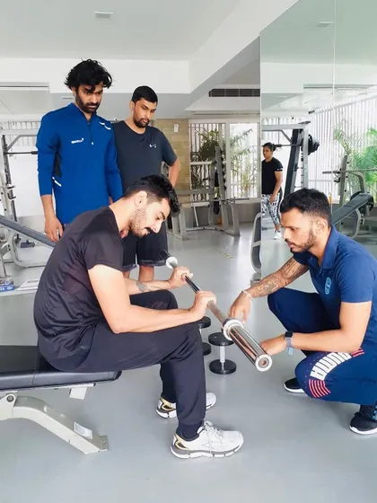 Hands-on guidance is a cornerstone of my mentorship. Here, I'm working with a coach during a CSCS practical workshop, focusing on precise technique and execution. My approach is collaborative; we discuss, question, and refine movements together.