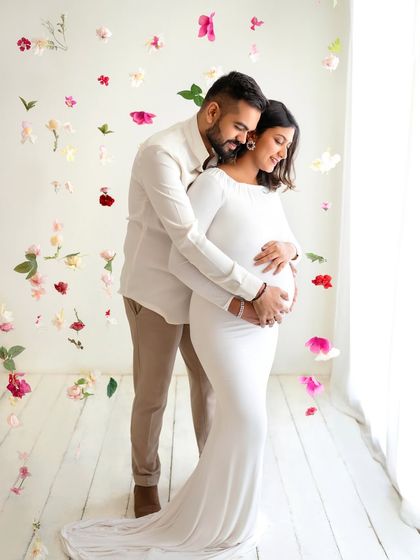 I love adding a touch of magic with these falling flower petals. It creates such a whimsical and romantic atmosphere for this beautiful couple's maternity shoot.