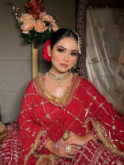 Another view of the red suit-style lehenga, highlighting the beautiful floral hair bun.