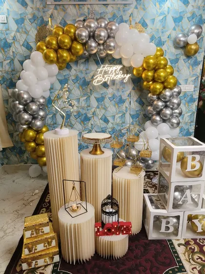 A sleek and modern birthday setup with a metallic gold and silver balloon ring, perfect for a stylish party.