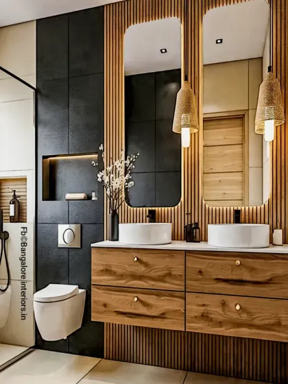 I transformed this bathroom into a spa-like sanctuary. The design combines bold black tiles with the warmth of fluted wood panels, a floating double vanity, and statement pendant lights for a touch of modern luxury.